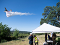 Click to see an image of a Firefighting tanker performing a water drop during a USFS/CalFire field demonstration