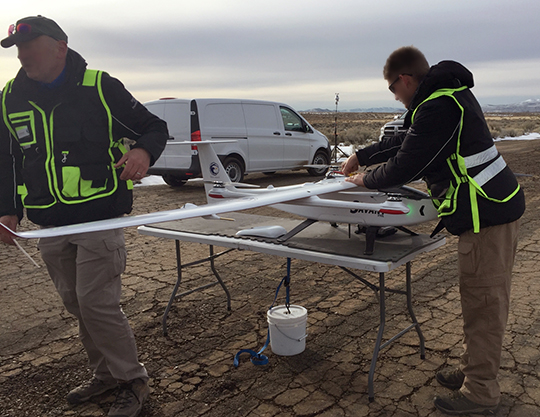 A crew prepares a vehicle for flight in during UTM system testing in May 2017